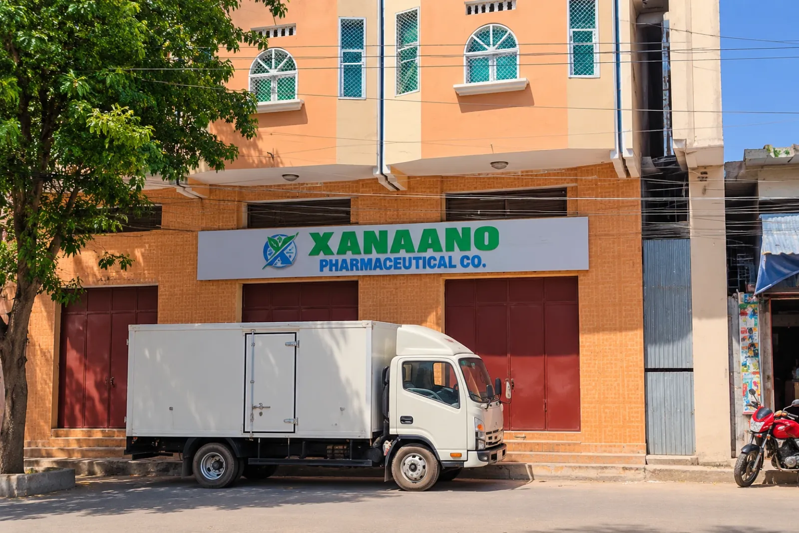 The Xanaano Pharmaceutical Co. storefront in Mogadishu, with a delivery truck parked outside